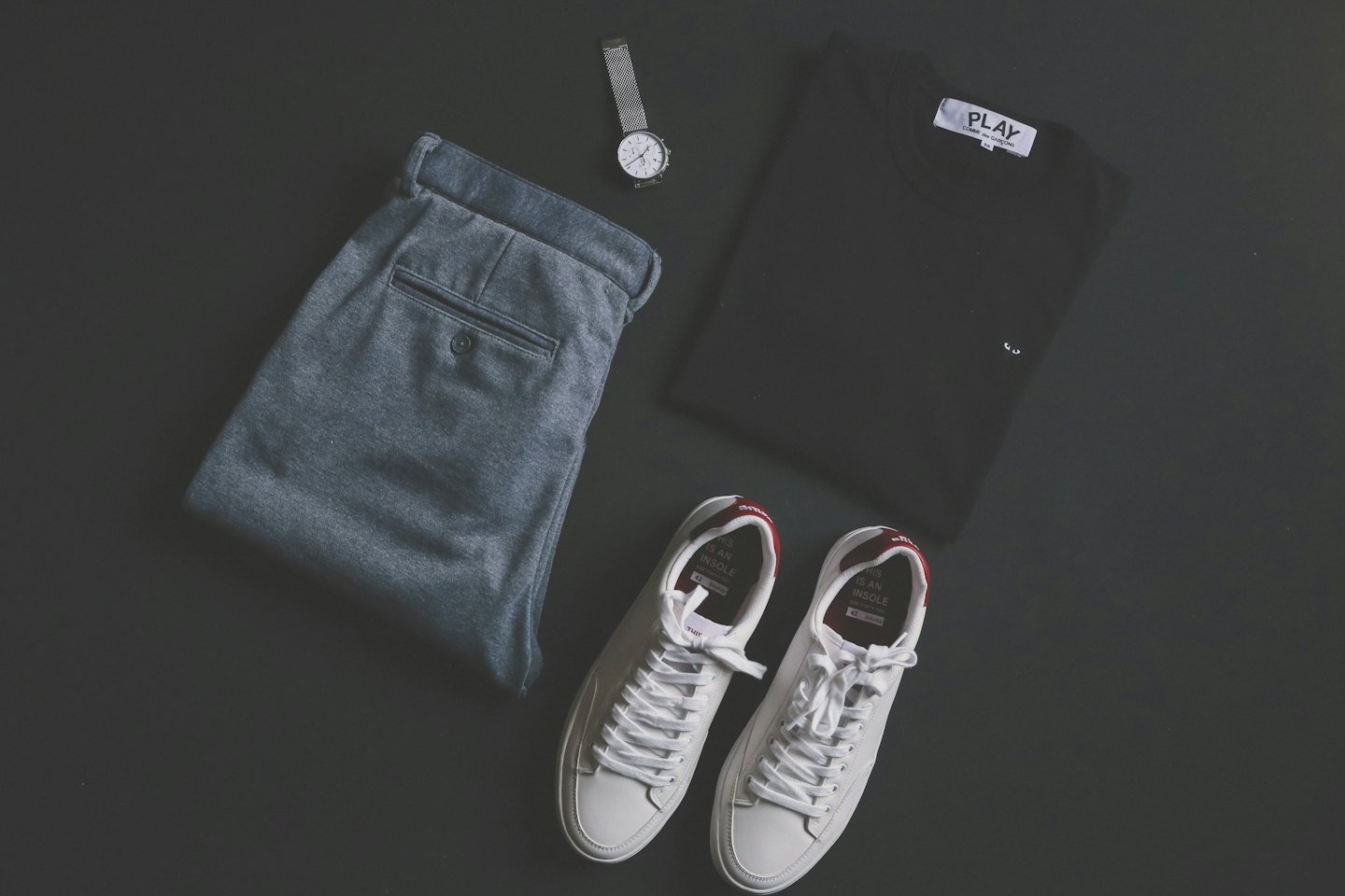 Men's casual outfit with trousers, shirt, watch, and sneakers.